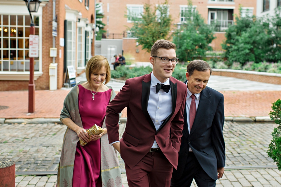 A groom walks with his parents to the ceremony at the Shambles in south Philadelphia.